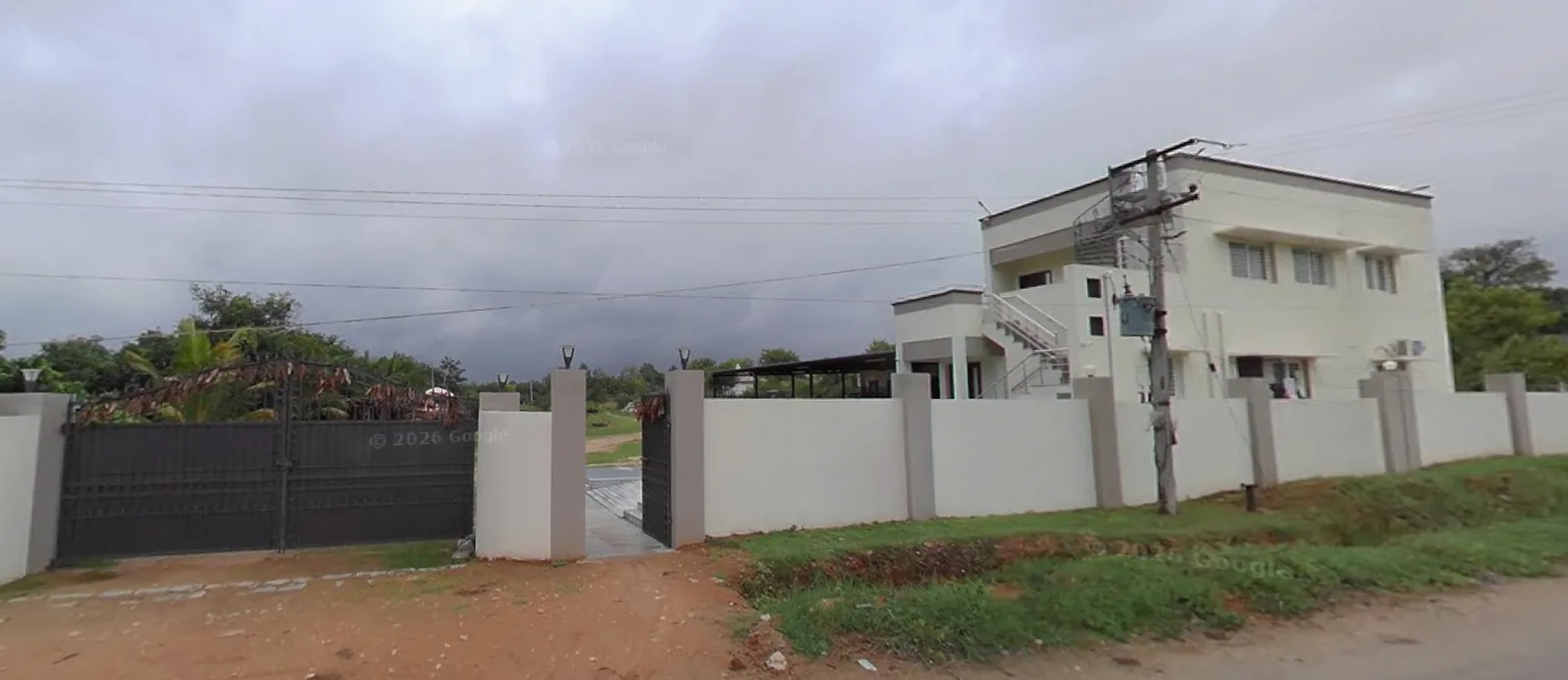 The MDR358 entrance to SVBS Fruit Farms and Exports — main gate on the village road